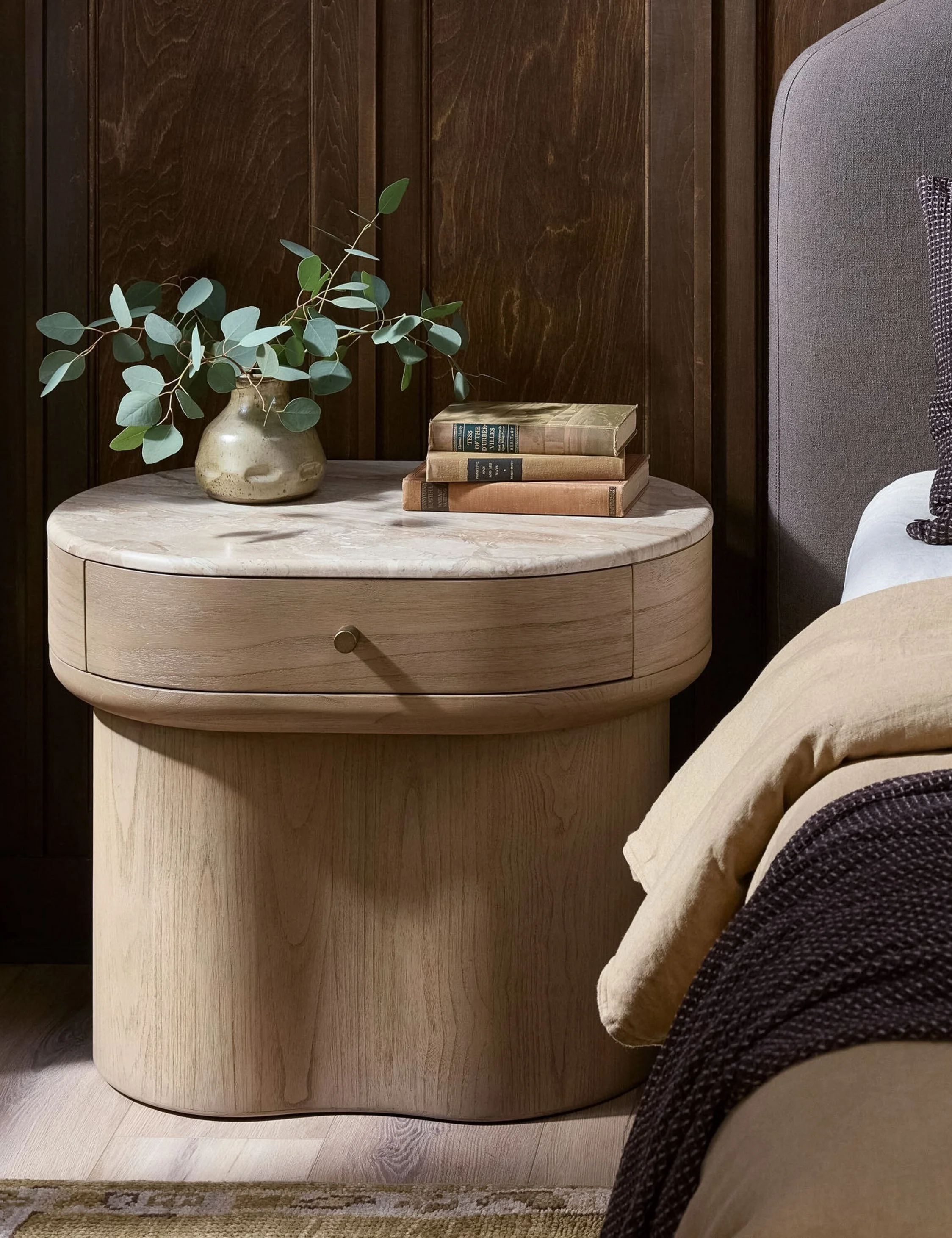 Nightstand - Warm wood, soft curves, and a cream marble top make the nightstand feel instantly elevated