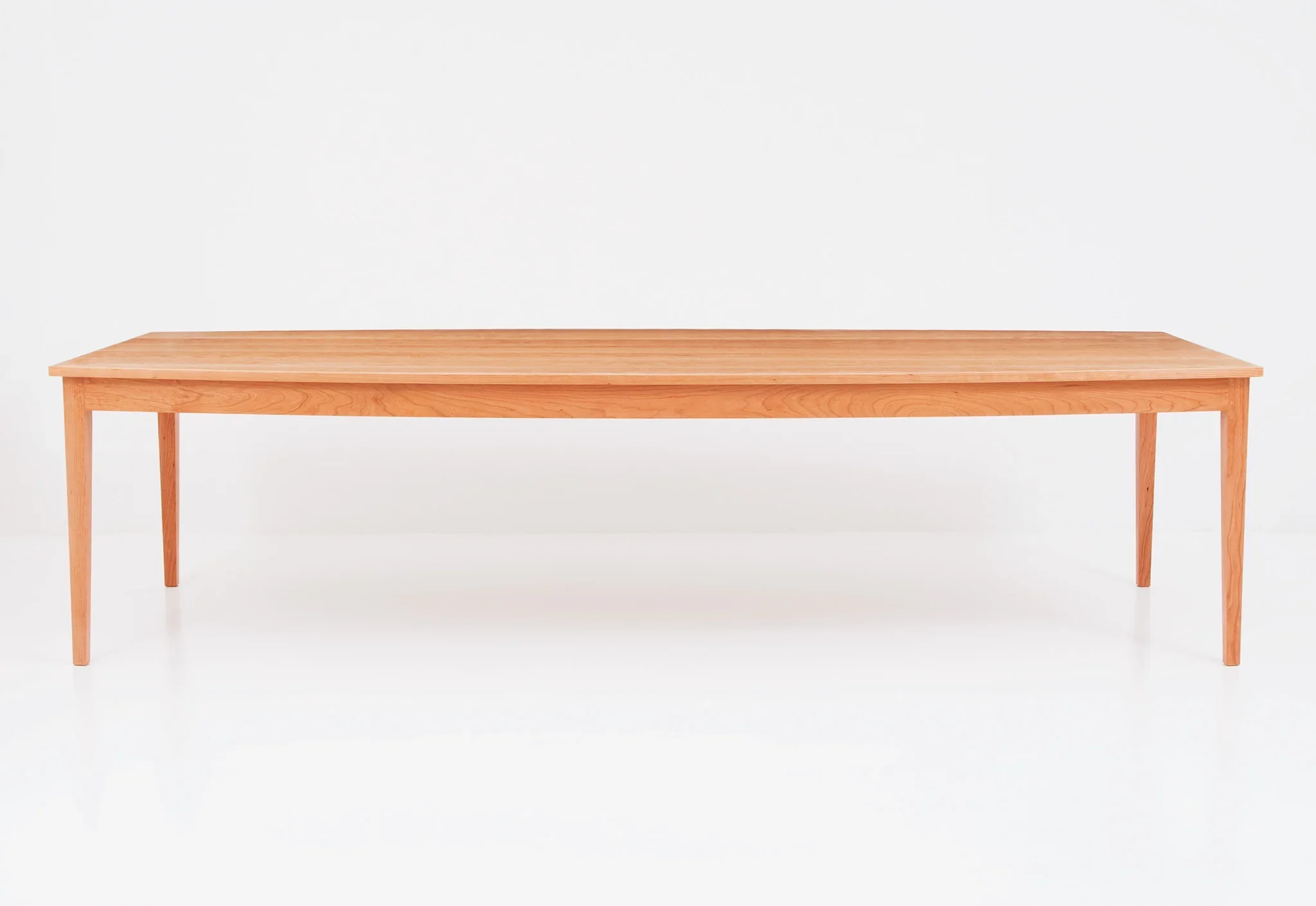 Boat Top Table - The table, which bows at its center, mimics the gentle curvature of the crest, arms and seat – forming