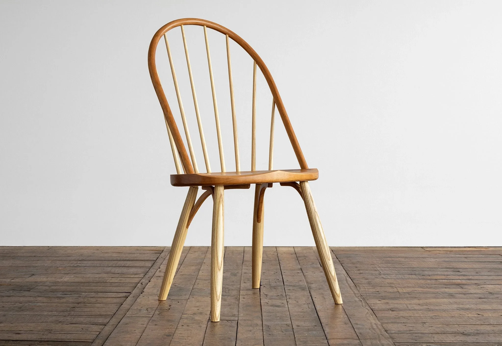 Bowback Chair - Distinctive for its unique flitch laminated bow, which arcs over eight slender ash spindles, the chair