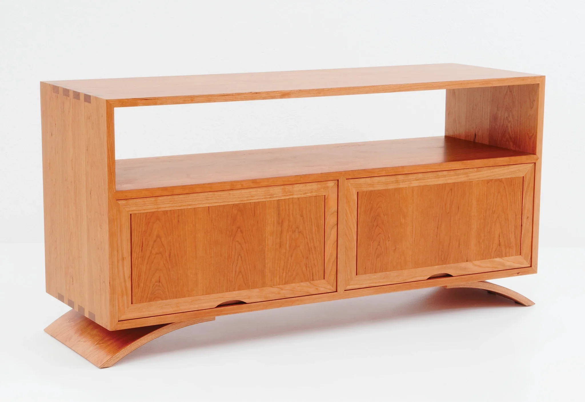Credenza - The Credenza has two exposed surfaces for lamps, photographs, and reading materials with an enclosed storage