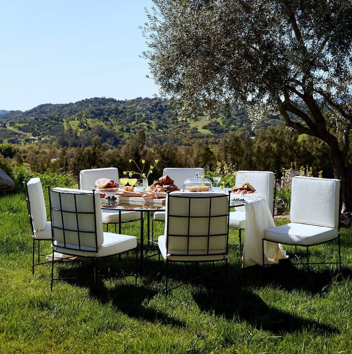 Outdoor Armless Dining Chair - Boucle - with a slender iron frame and upholstered in plush outdoor boucle, it’s designed to withstand the elements...