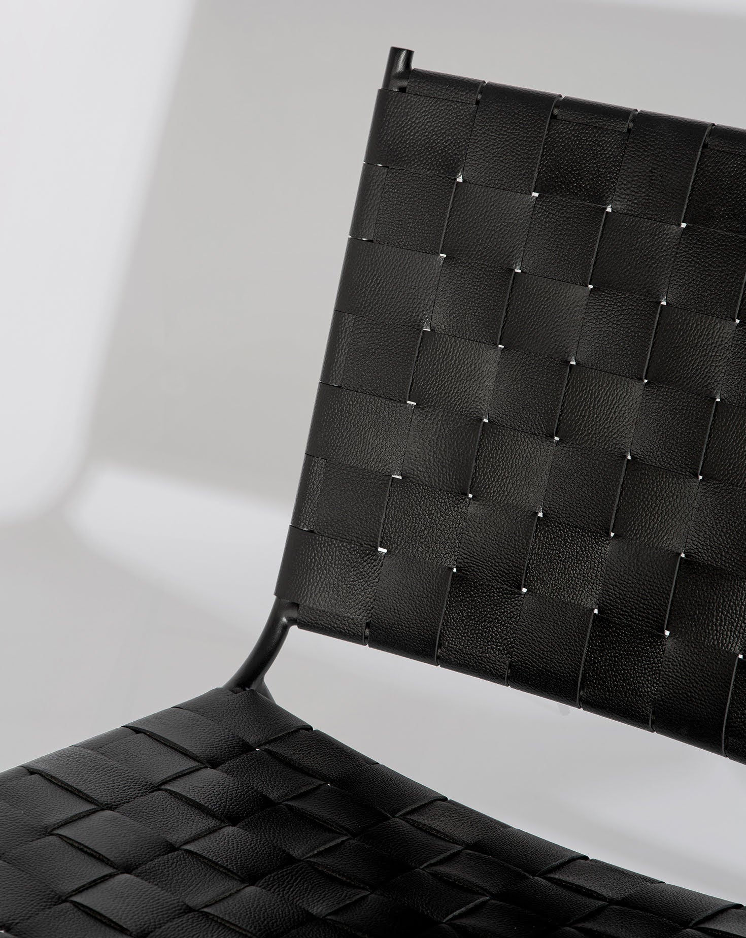 Black Leather Strap Woven Steel Frame Lounge Chair