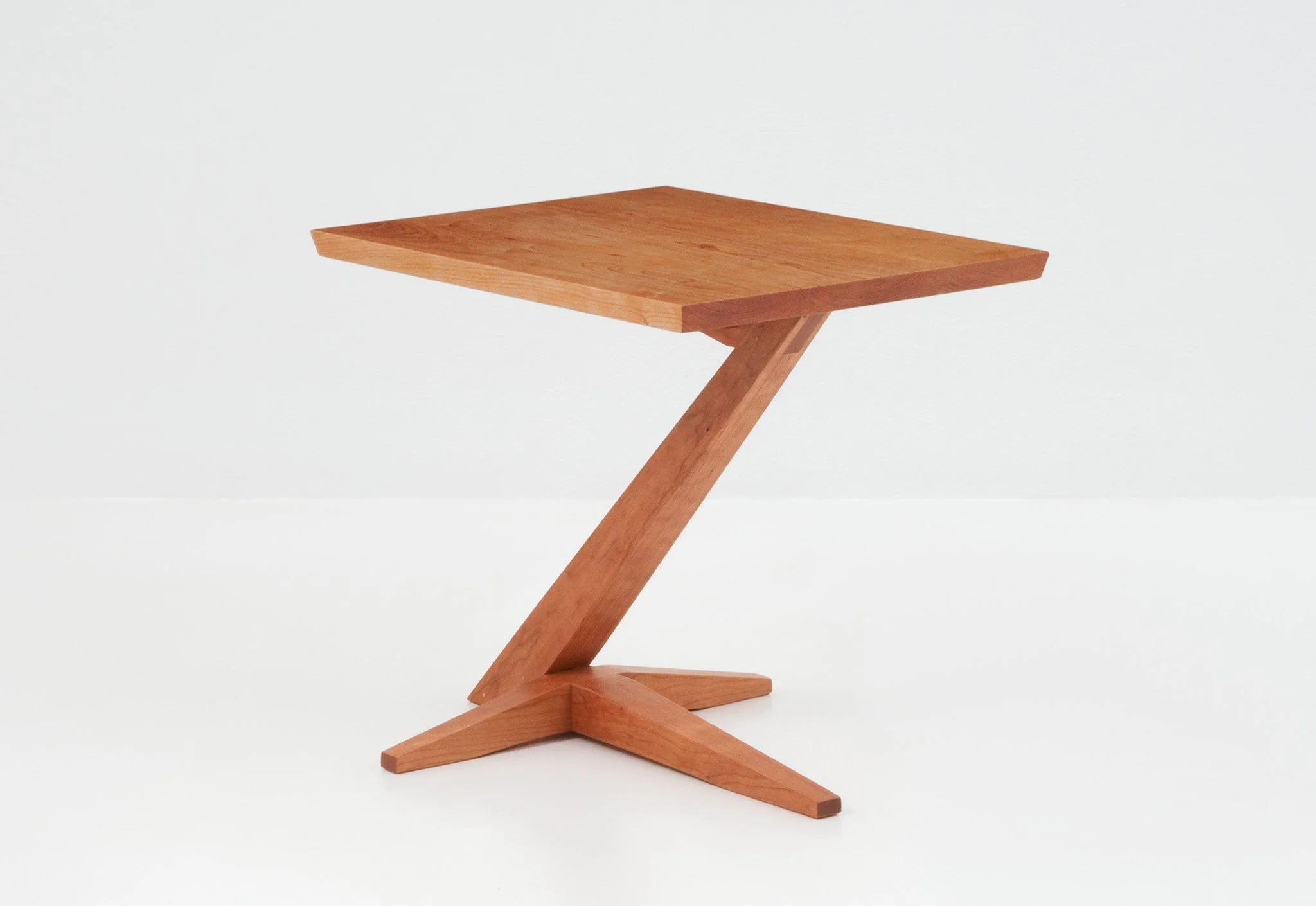 Cantilever Side Table - Perched atop a solid cherry or walnut base that rises from its splayed foot on a