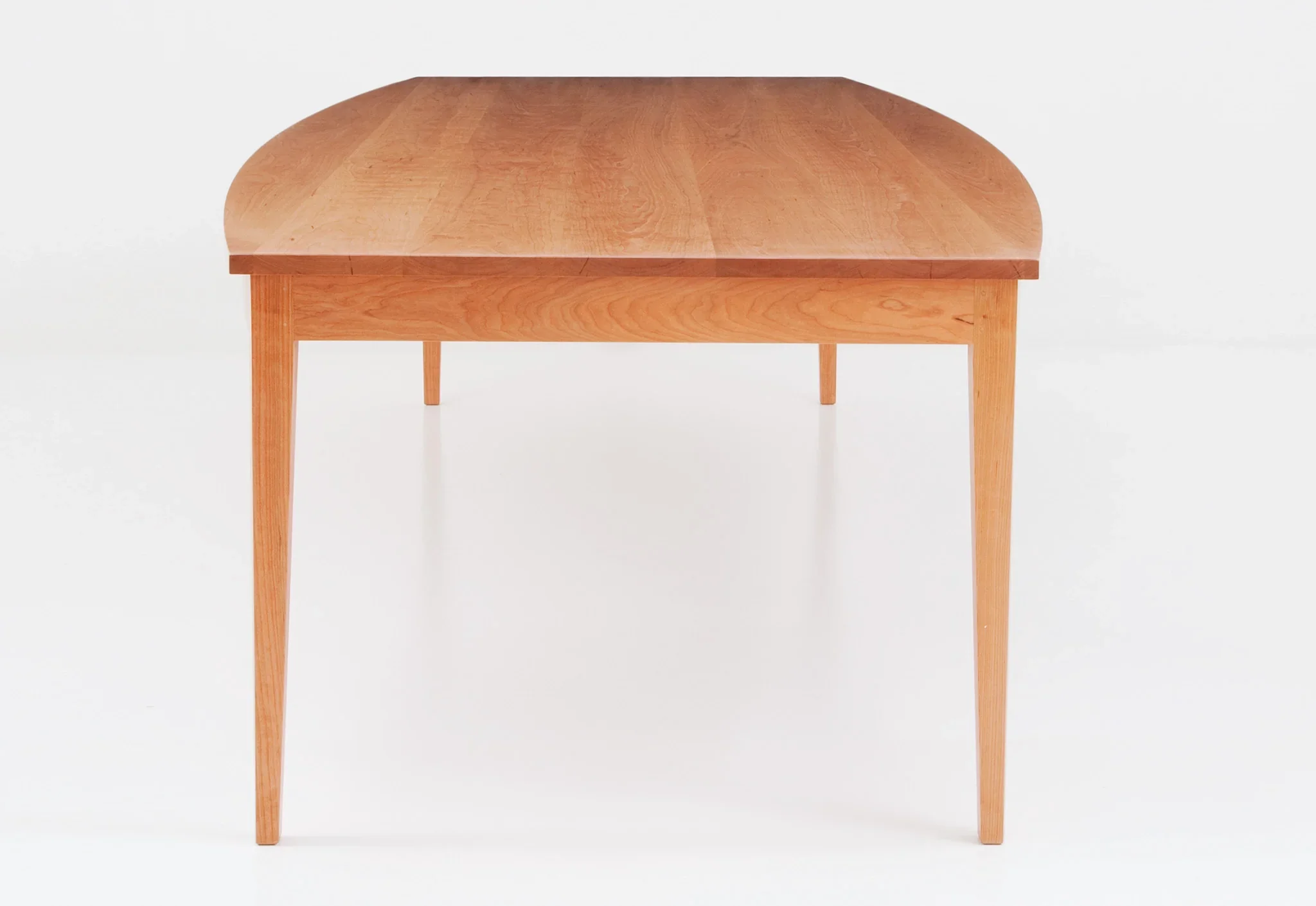Boat Top Table - The table, which bows at its center, mimics the gentle curvature of the crest, arms and seat – forming