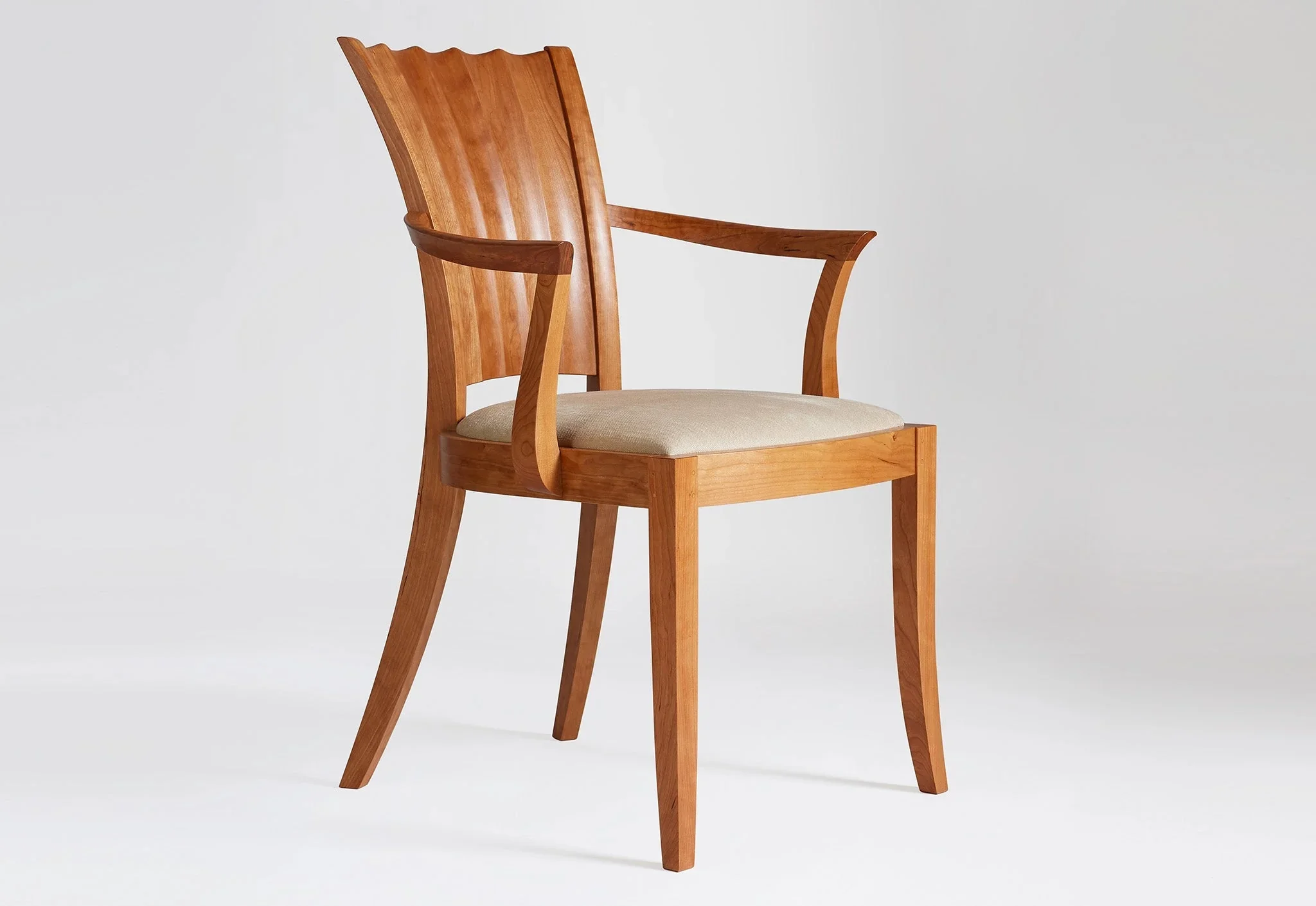 Arm Chair - The hourglass lines of the – seen in the hand-carved convex and concave curves of its distinctive back