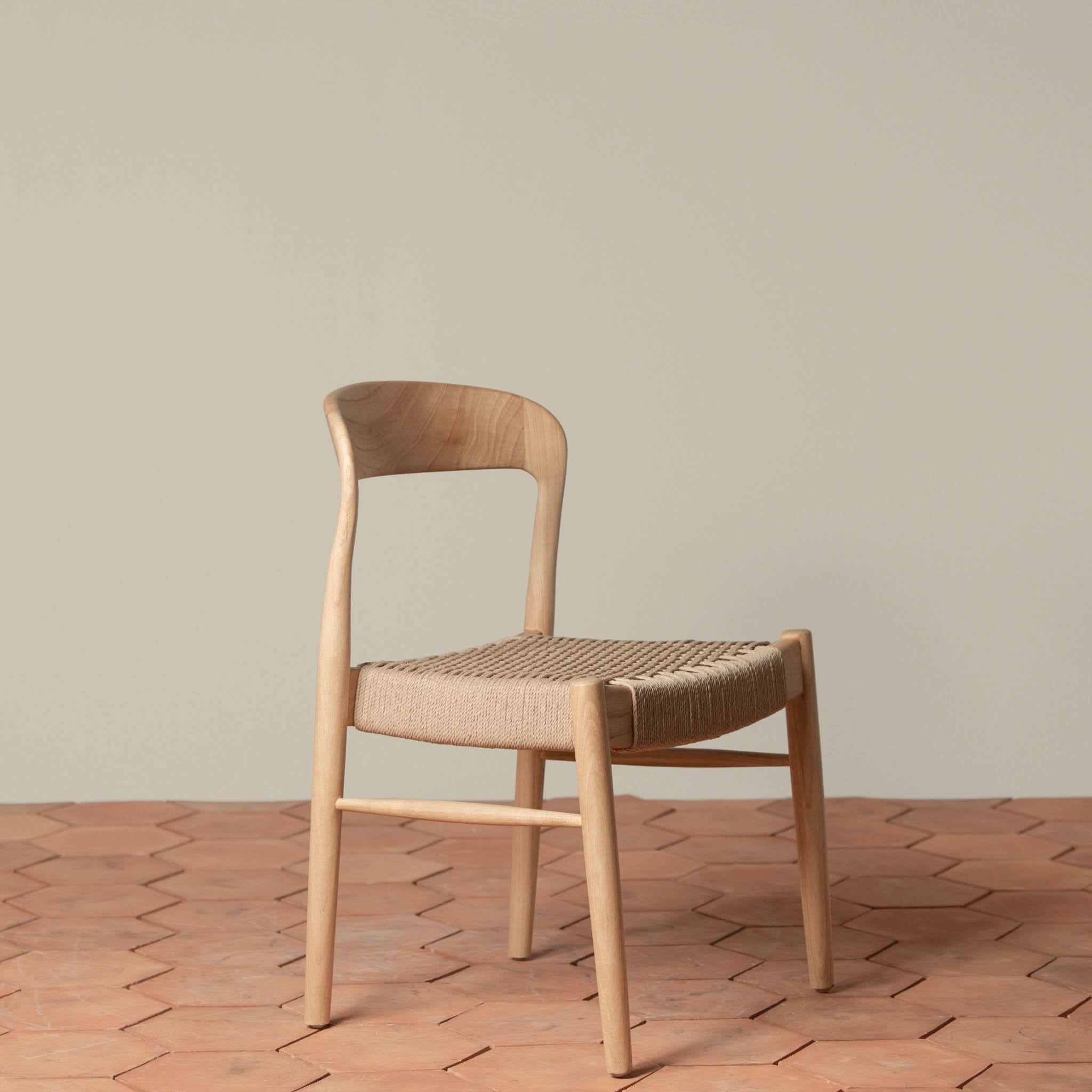 Side Chair - Available in multiple finishes, the ’s sculptural lines, curved back, and generously sized hand- loom seat balance form and texture...