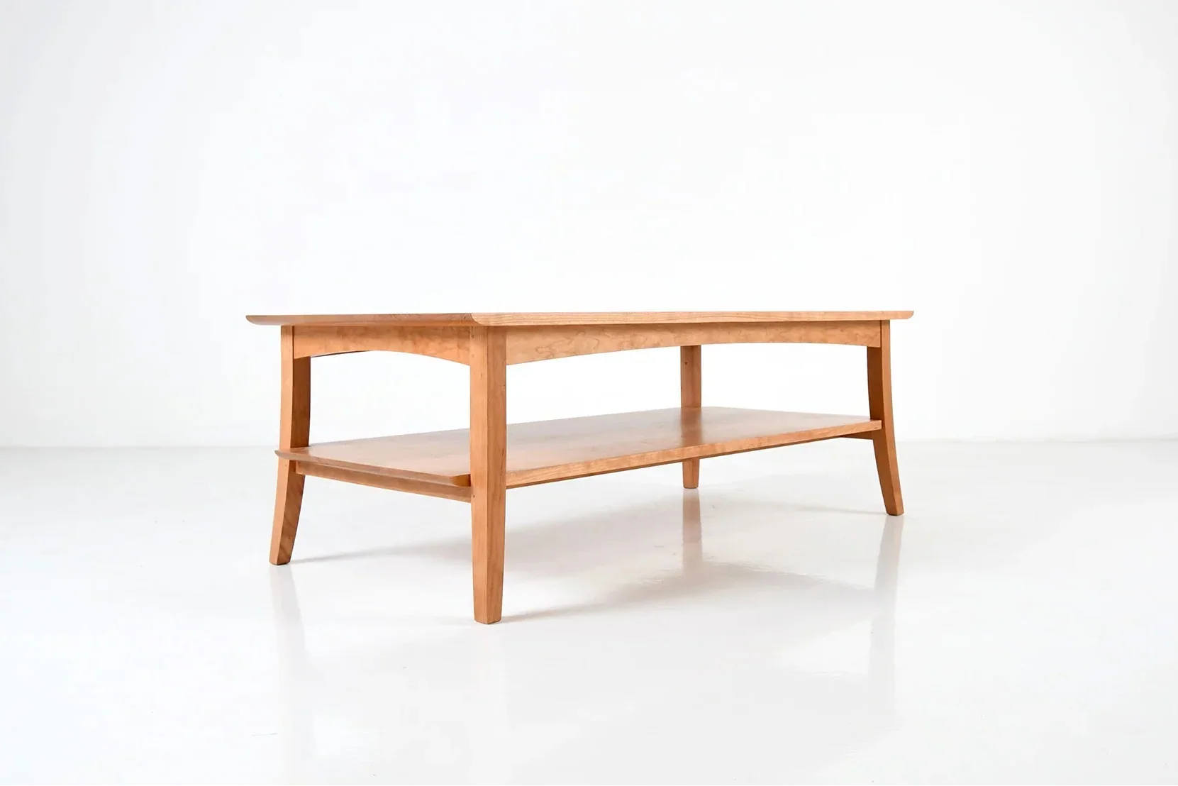 Coffee Table - Ideal for living spaces or conversational areas, the table has a simple notched shelf beneath the