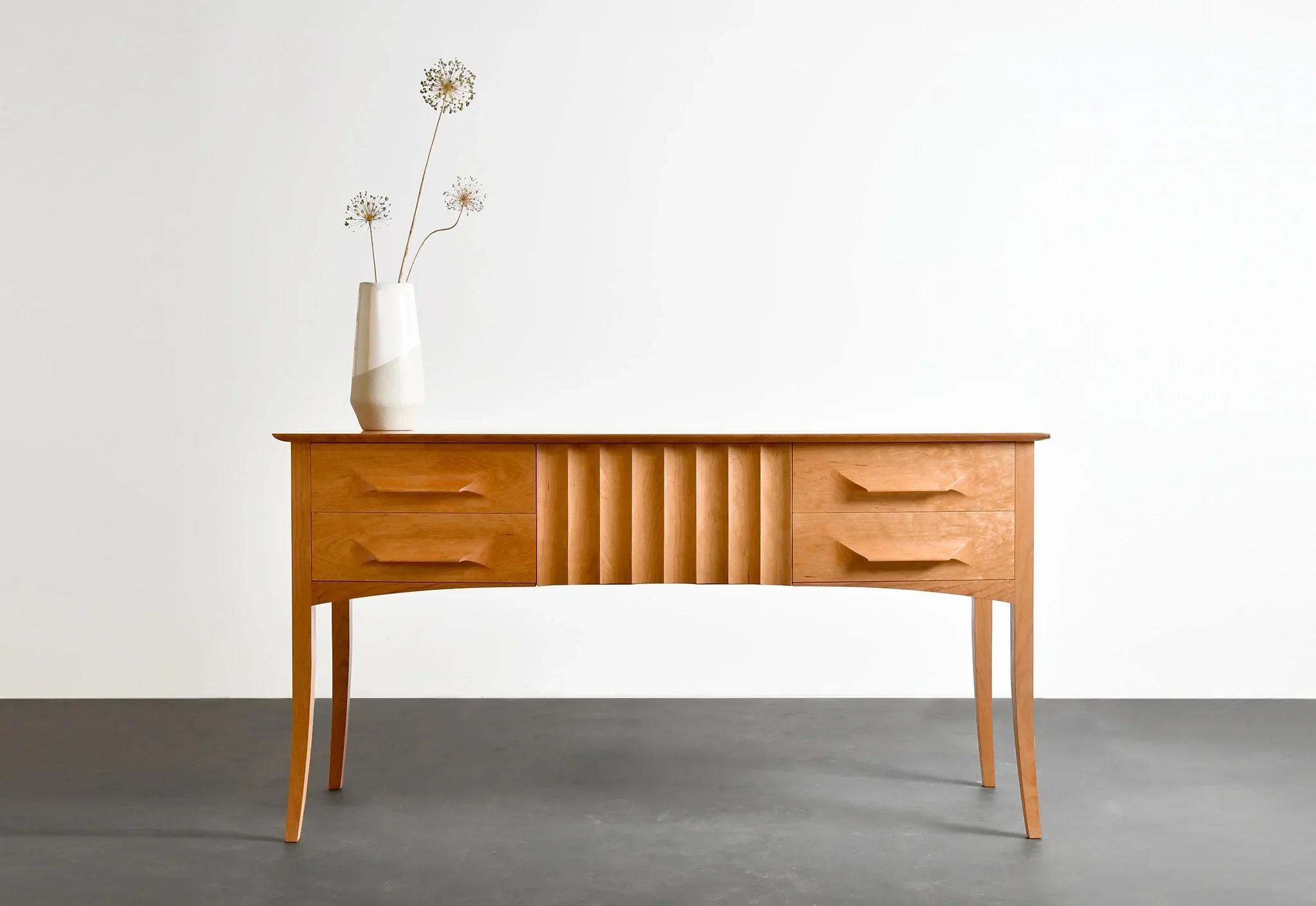 Sideboard - Presenting front and center, the incorporates a center drawer face assembled of grain-matched vertical