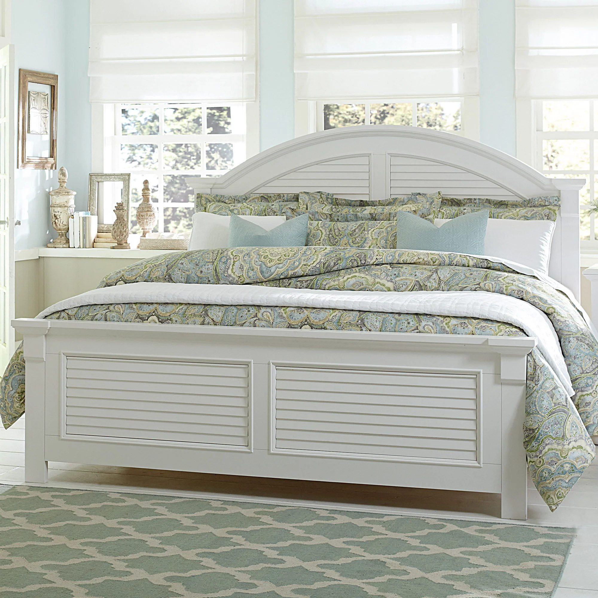 Panel Bed — The oyster white finish is accented by louvered panels and arched crown molding