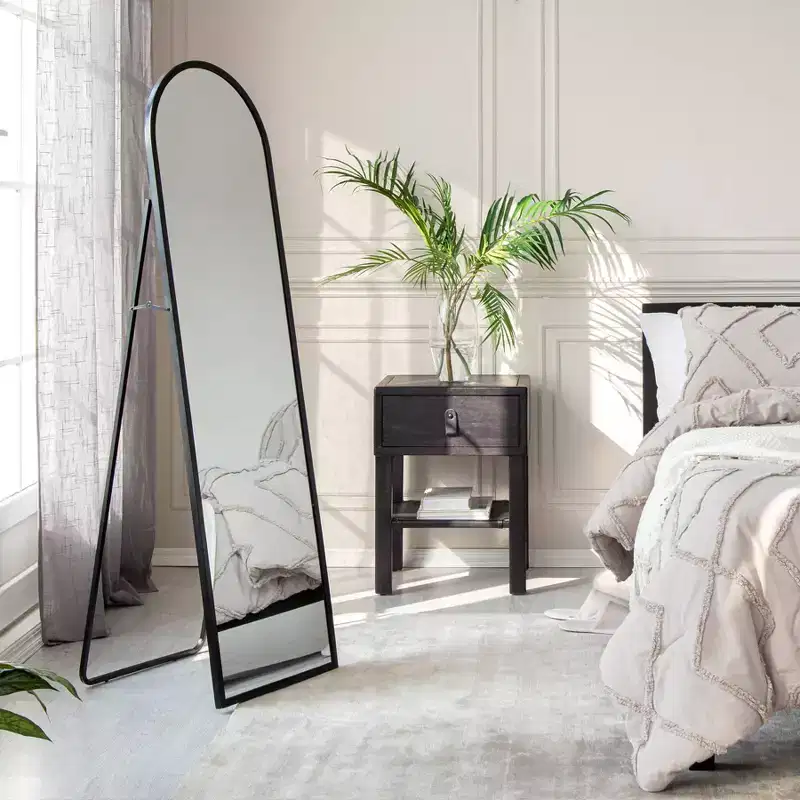 Black Arched Mirror: 60-inch modern floor mirror, metal frame, freestanding, 18 inches wide.