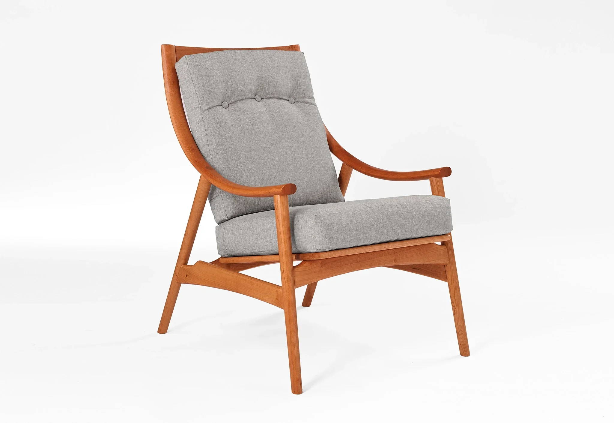 Lounge Chair - Designed with sweeping, curved arms, slender spindles along the back, and slender, gently raked legs