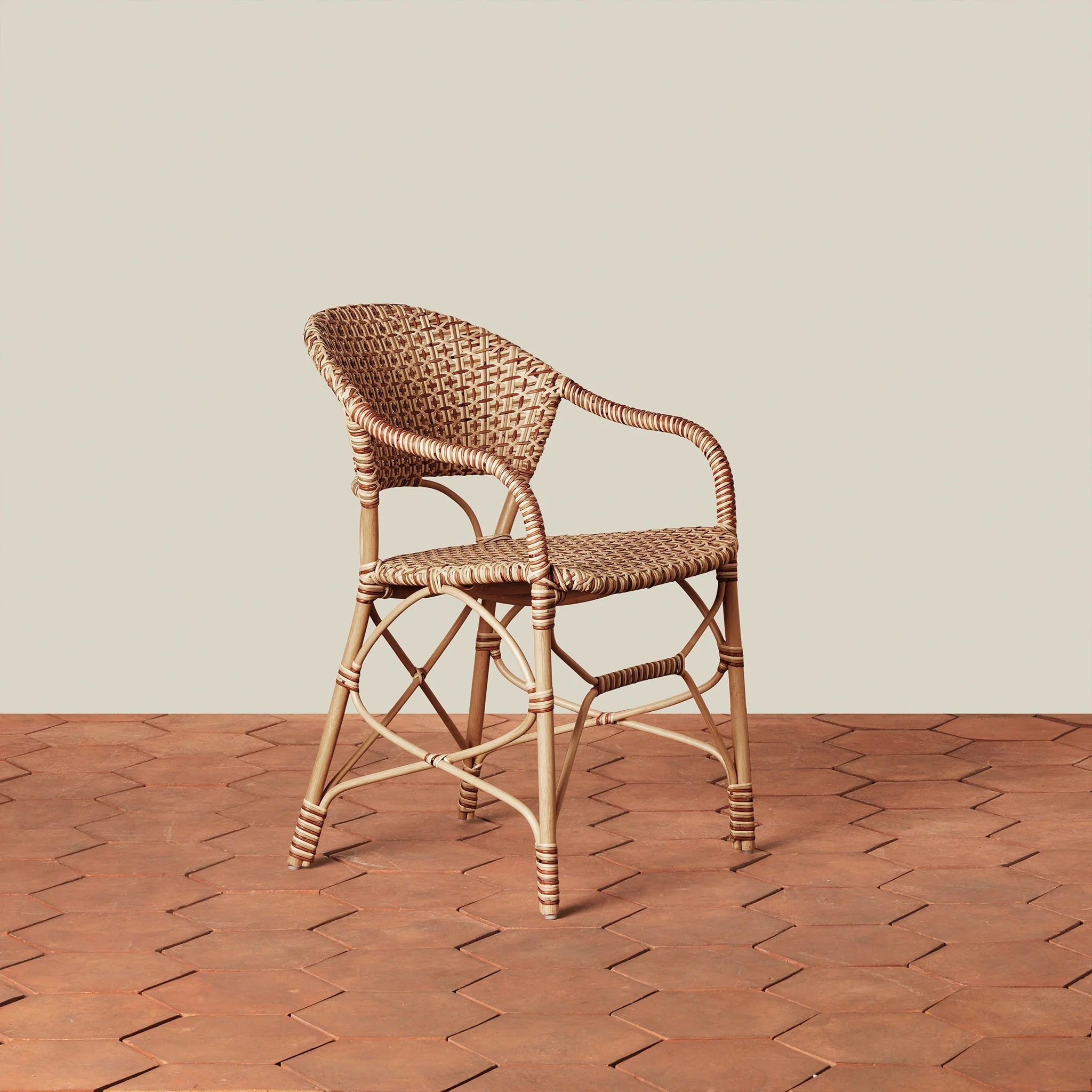 Arm Chair - handwoven from sustainably sourced rattan, its earthy palette and elegant silhouette bring timeless style to both casual kitchens and...