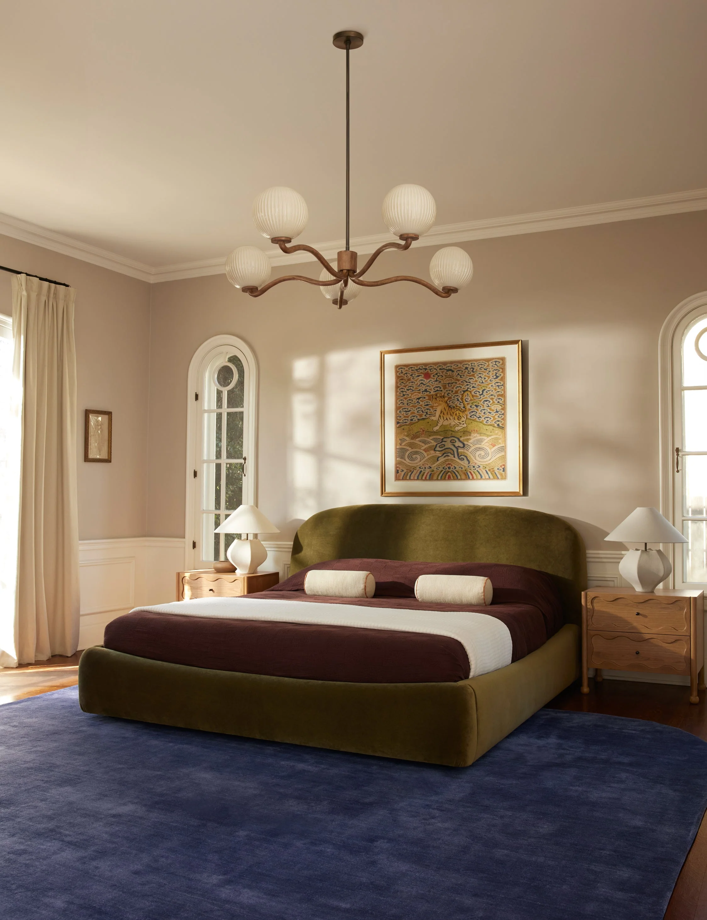Bed Headboard The bed embodies comfort with sophistication, featuring supple upholstery and a soft, sculpted headboard. We love how